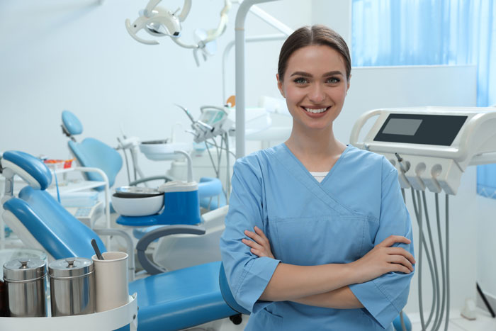 portrait-of-the-dentist-professional-at-the-work-place-in-the-clinic-blue-coat